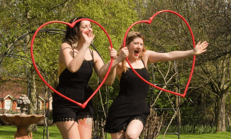 loe hula hooping! Carla and Sally pose with heart shaped hula hoops looking super happy!